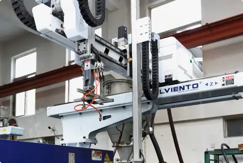 Robotic arm and automation machinery in a manufacturing plant, showcasing advanced industrial automation technology used for assembly and production processes.