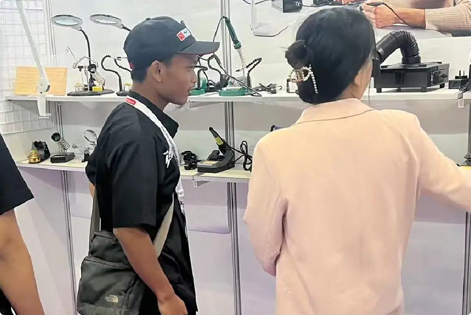 Smartwatch and electronic gadgets showcased at a technology exhibition, with visitors exploring the latest innovations in wearable tech and consumer electronics.
