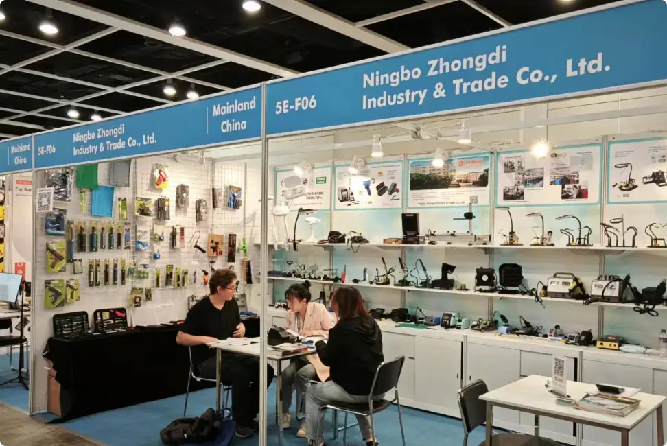 Ningbo Zhongdi Industry & Trade Co. booth showcasing electronic components and tools at a trade exhibition, with visitors engaging with products and representatives.
