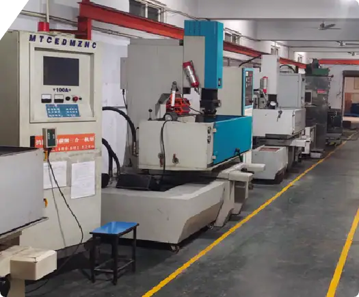CNC machining tools in an industrial manufacturing facility, used for precision metal and plastic parts production. The image shows multiple CNC machines aligned in a factory setting, emphasizing auto.