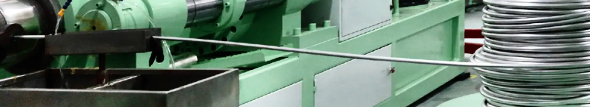 Industrial paper processing machine with rolls of paper and green machinery for manufacturing.