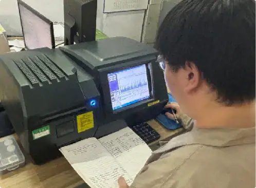 Laboratory technician working with scientific equipment and data analysis in a research lab setting.