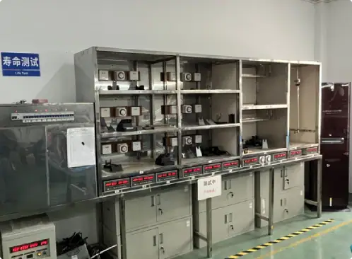 Quality battery testing station with multiple test units and electronic equipment for battery performance analysis and quality control in a laboratory setting.