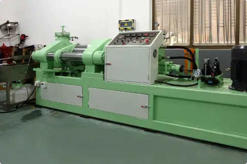 Precision green industrial metal lathe machine with control panel in a manufacturing workshop.